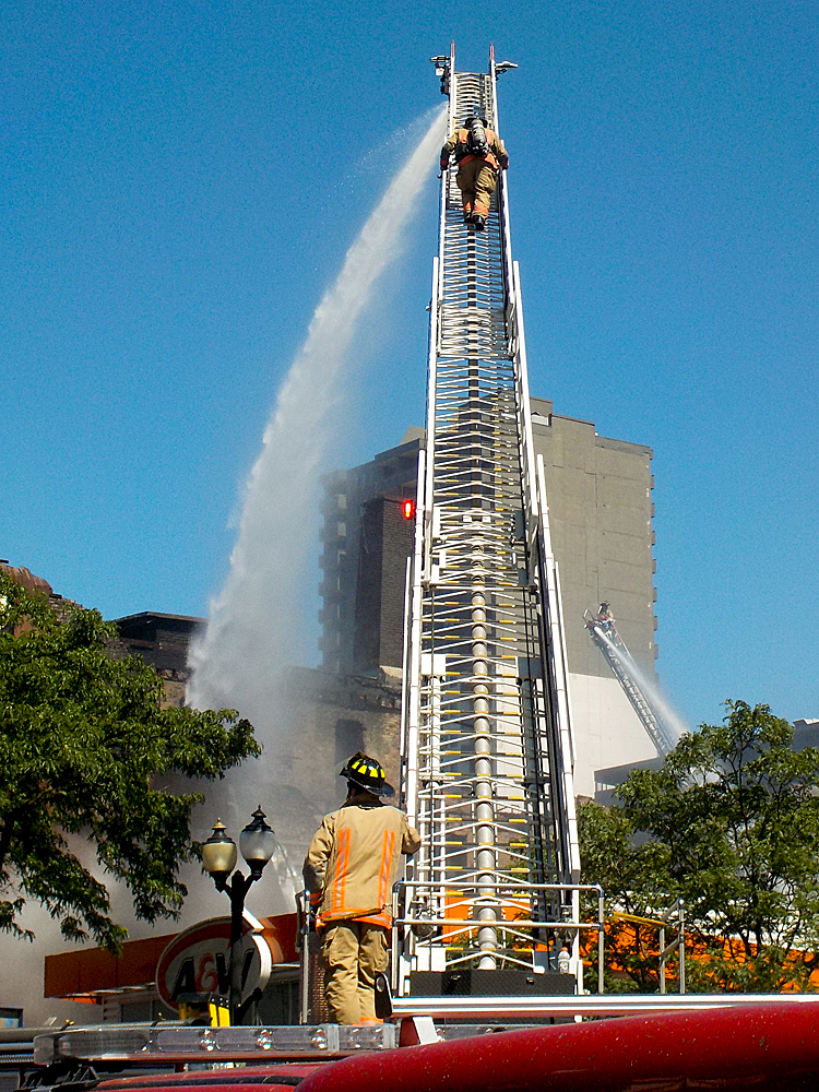 TWO FIRE-FIGHTERS with ONE AT THE BOTTOM and ONE WAY UP by Timothy Morton, APSA