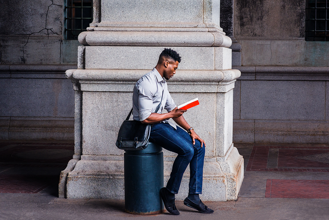 Young Black Man Studying on Street in New York City by Xiao Cai