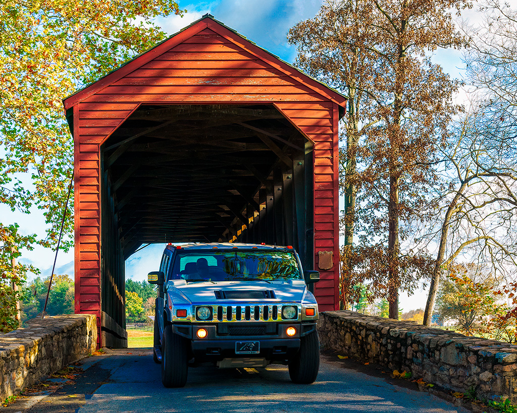Covered Bridge with Hummer by Eric Schweitzer
