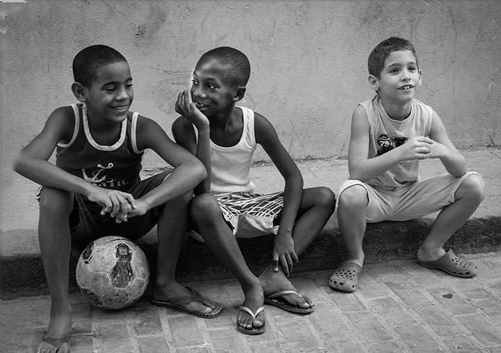 Three Cuban Boys Relaxing by Joan Field