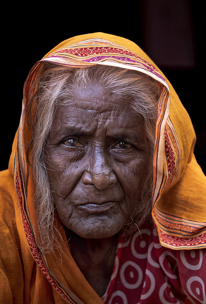 Woman in orange saree by Dr Aishwarya Mukherjee