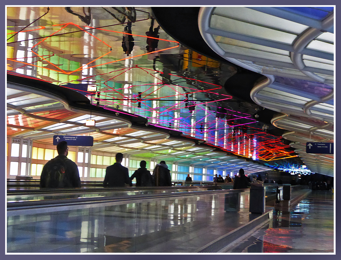 Travelers under Colorful Lights at Chicago airport by Shirley Ward