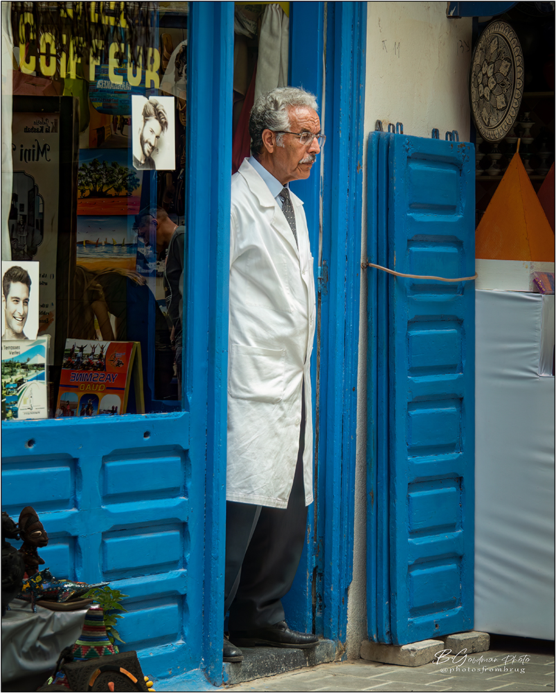 The Barber and Reflections in the Window, Morocco. by Bruce Goodman