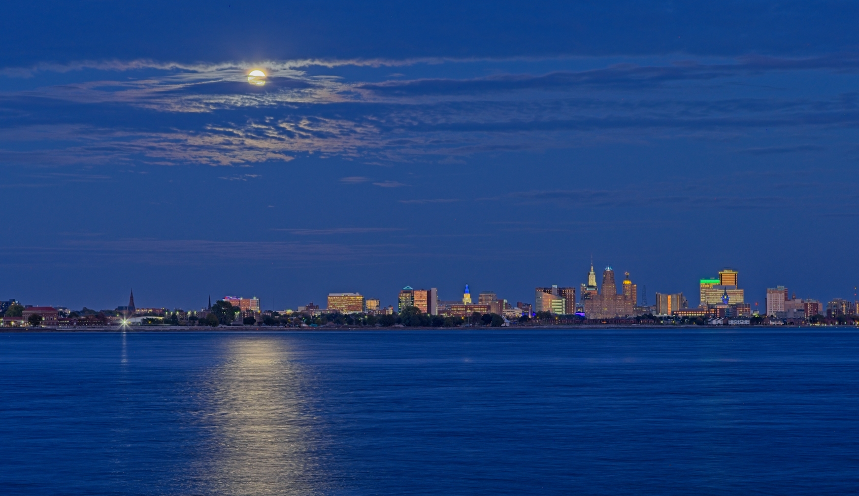 Harvest Moon over Buffalo, NY during the "blue" hour by Pierre Williot