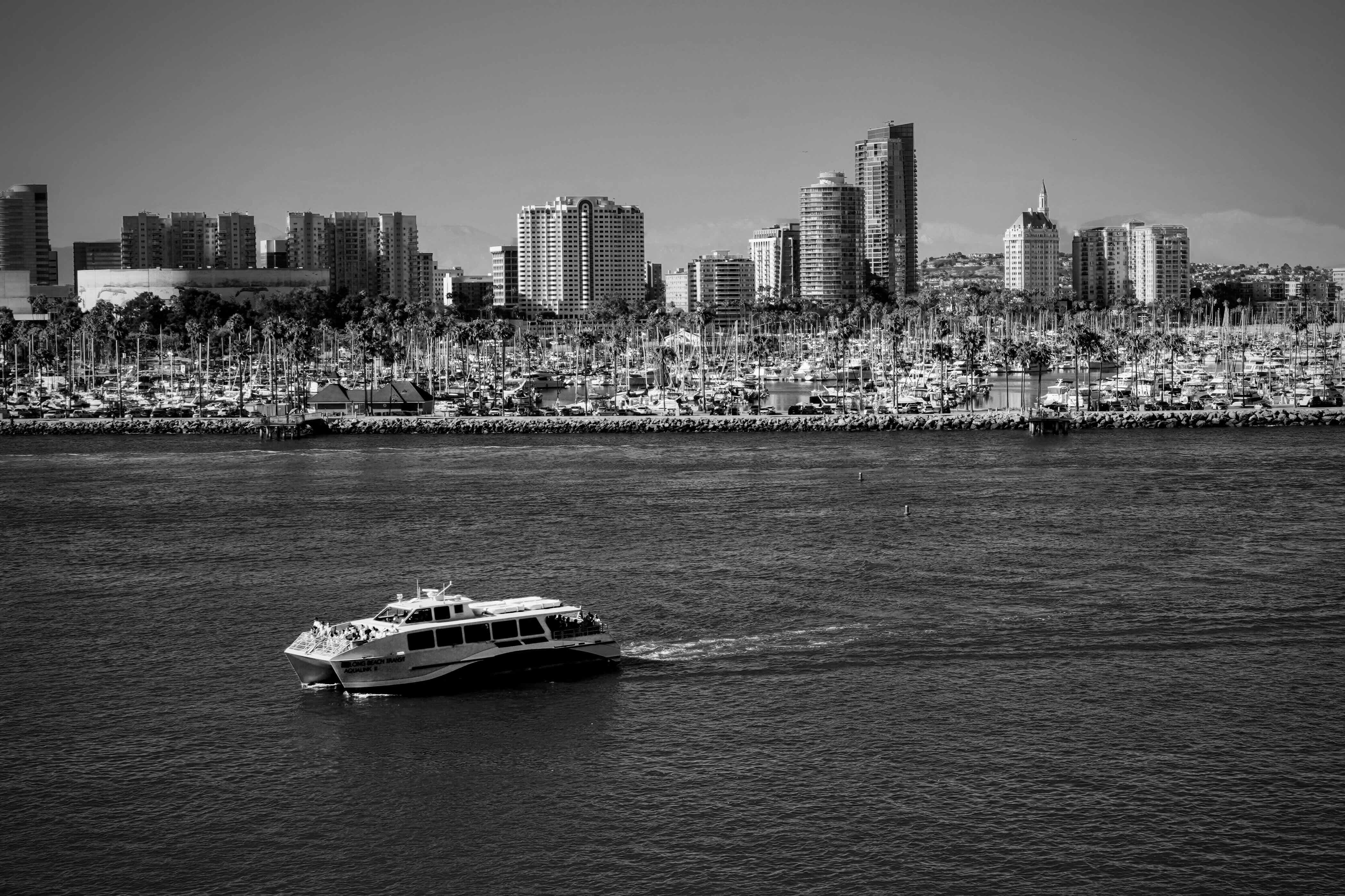 Water Taxi ferrying people in Queensway Bay by Dennis Lee